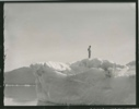 Image of MacMillan standing on iceberg